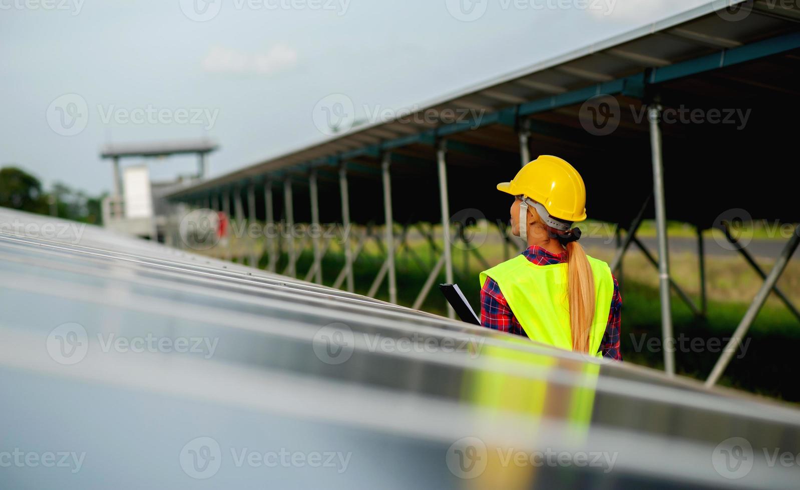 A young female solar cell engineer is working hard. Working in alternative energy Solar energy photo