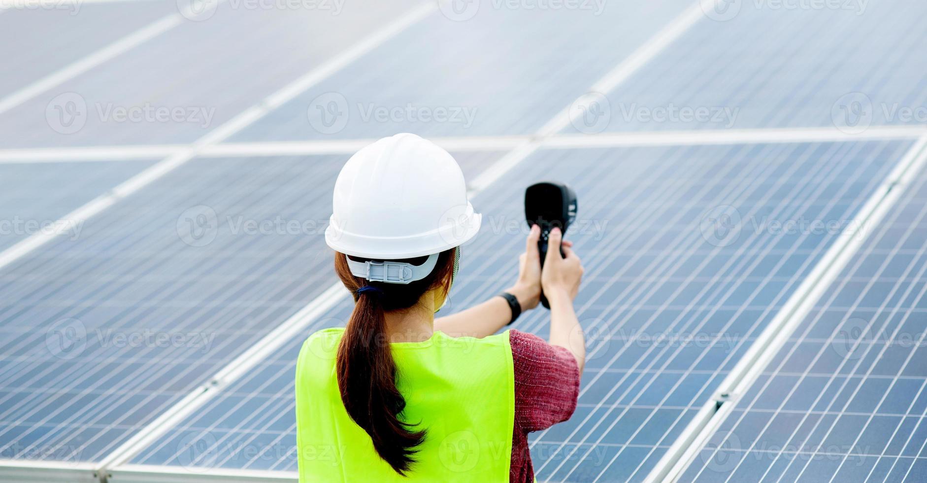 A young female solar cell engineer is working hard. Working in alternative energy Solar energy photo