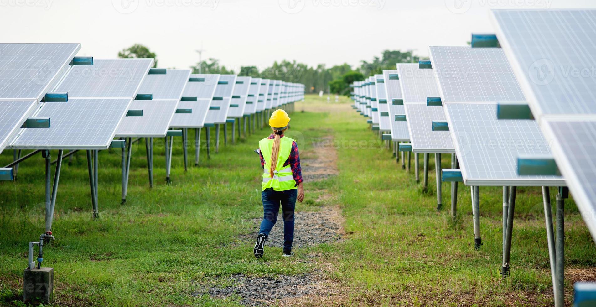 A young female solar cell engineer is working hard. Working in alternative energy Solar energy photo