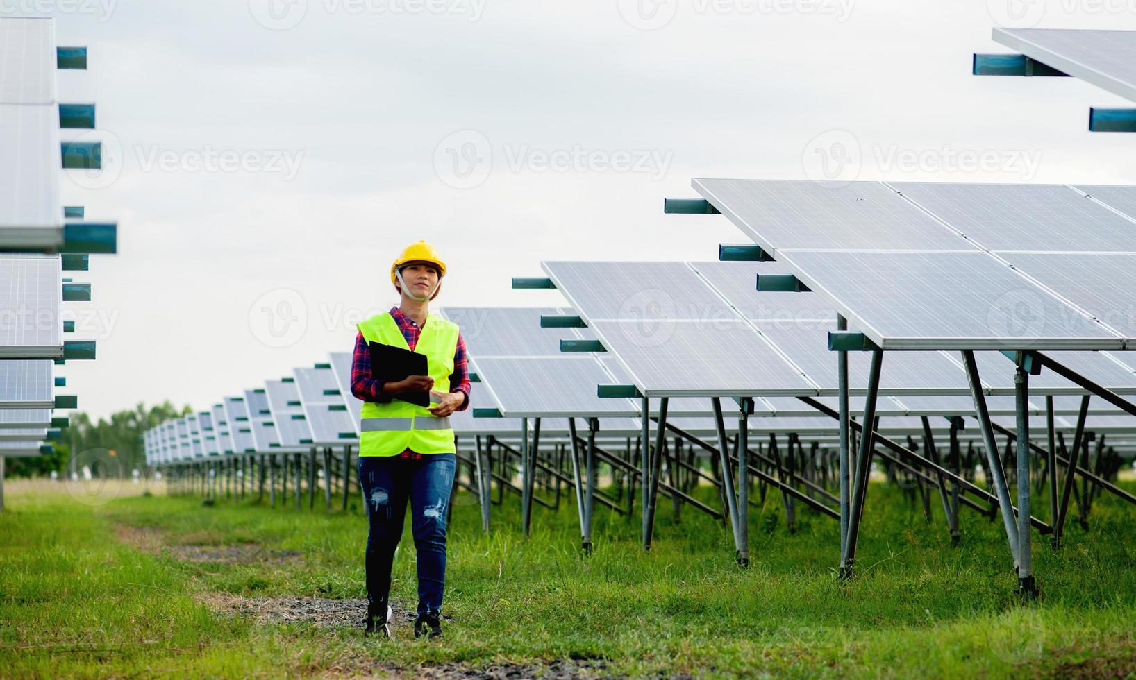 A young female solar cell engineer is working hard. Working in alternative energy Solar energy photo