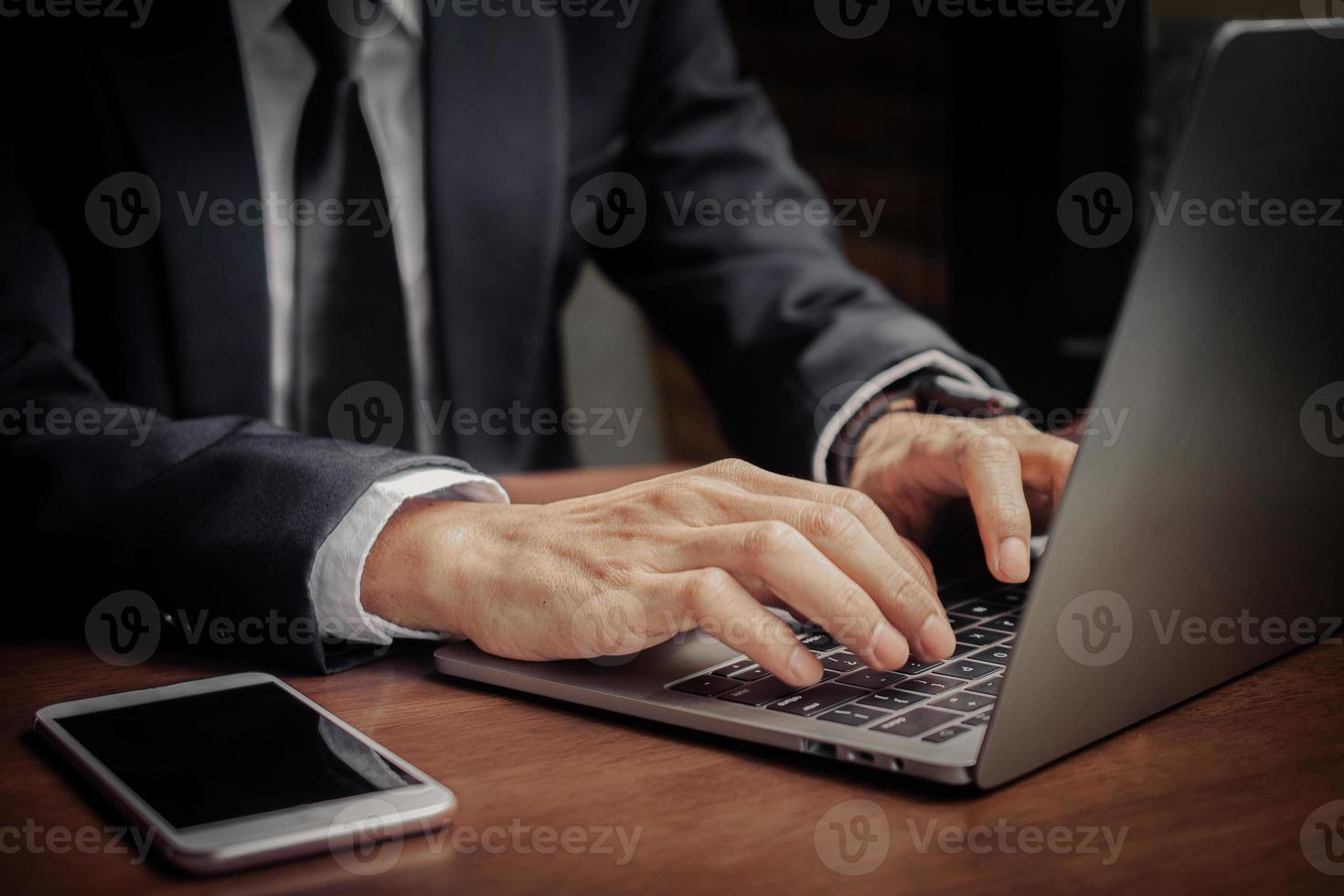 Close up hand using computer, Businessman typing laptop photo