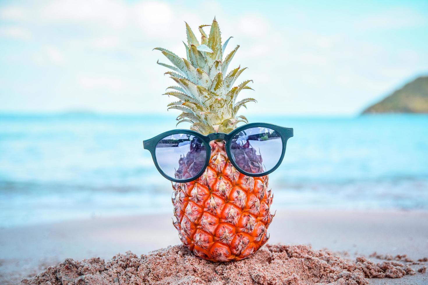 Pineapple And Sun Glasses On Beach st Sea Summer Background Concept photo