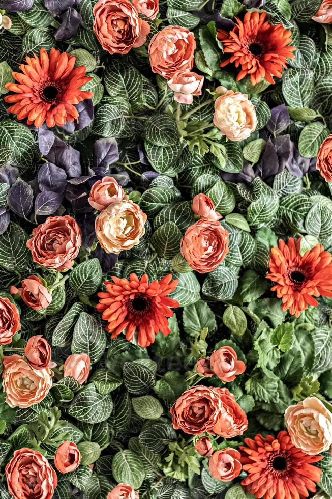 Background of spring artificial red chrysanthemums and peony roses in the garden. Spring. Blooming wall photo