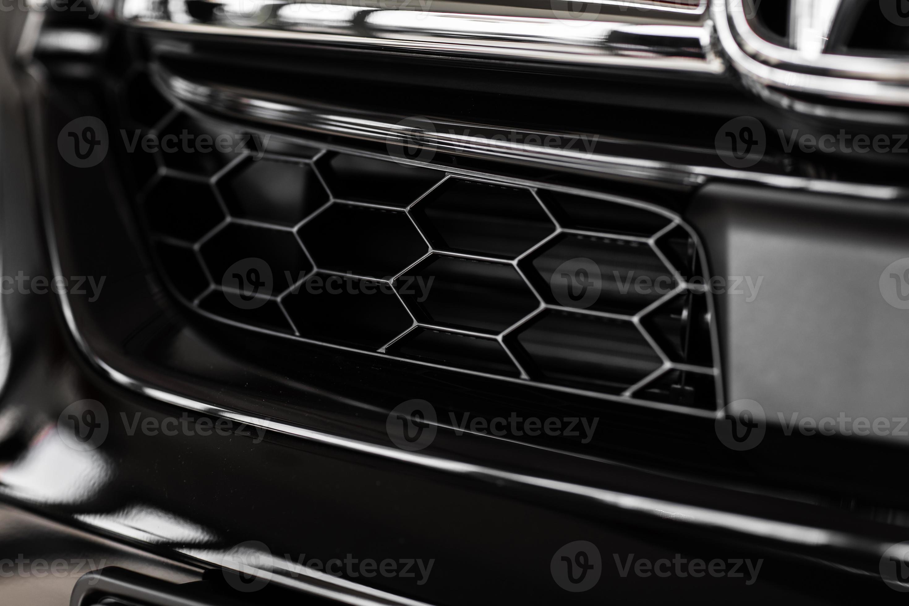 Grid of white sports car. The radiator grille. Metal texture. chrome