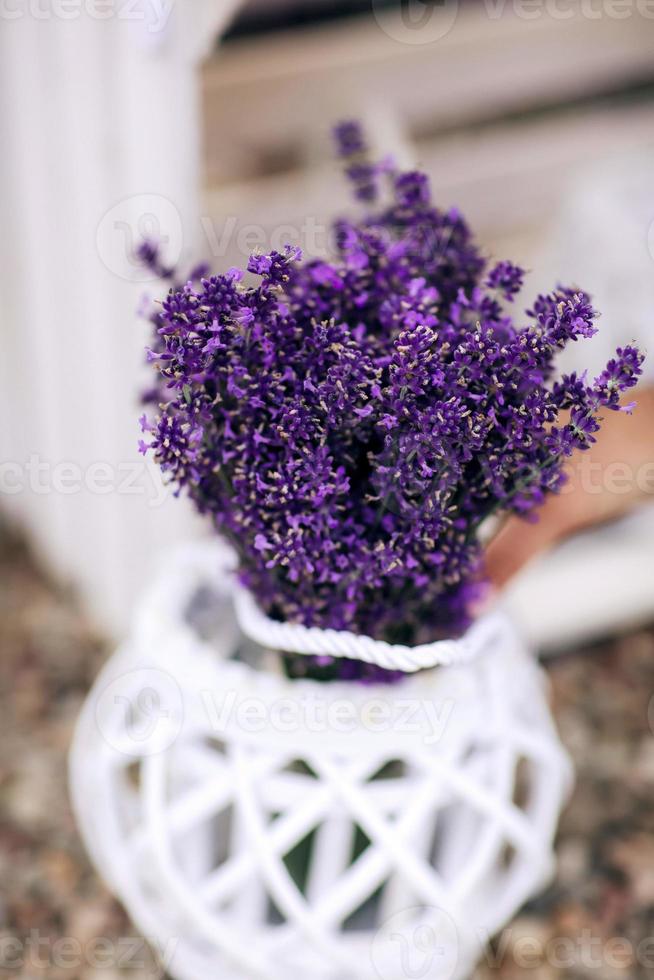 Pile of lavender flower bouquets on a wooden old bench in a summer garden. bouquet of lavender photo