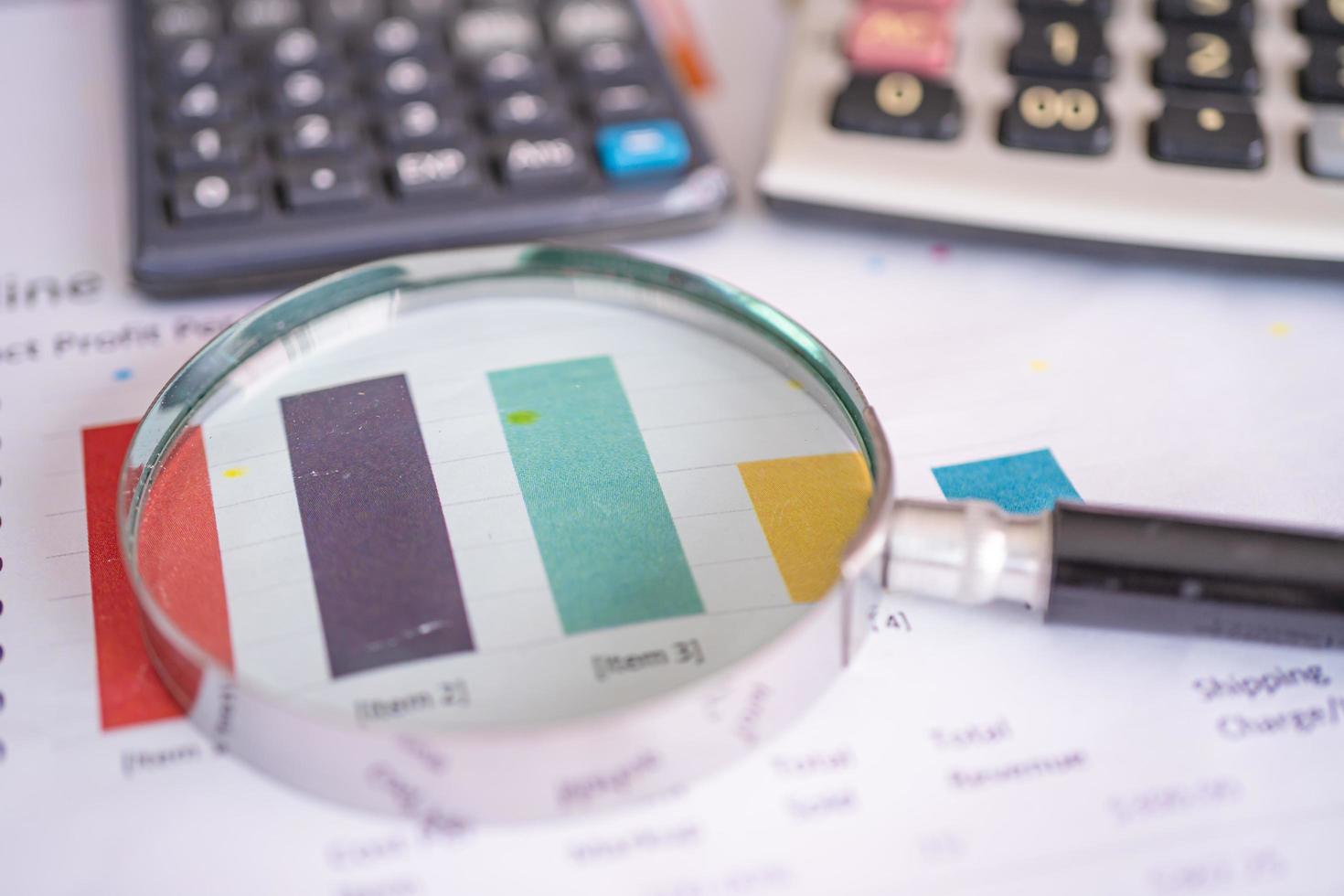 Magnifying glass on charts graphs paper. Financial development, Banking Account, Statistics, Investment Analytic research data economy, Stock exchange trading, Business office company meeting concept. photo