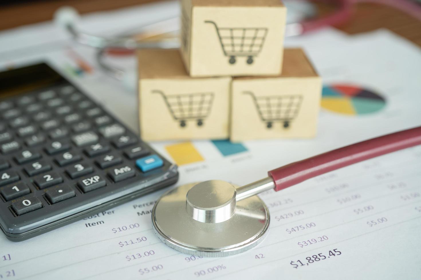 Shopping cart logo on box with magnifying glass on graph background. Banking Account, Investment Analytic research data economy, trading, Business import export transportation online company concept. photo