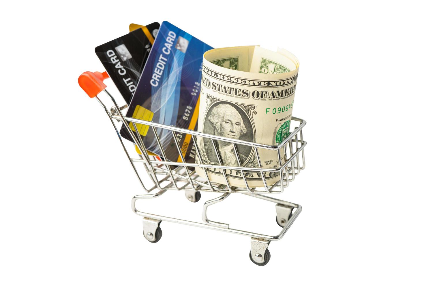 Credit card and US dollar banknotes in shopping cart isolated on white background, finance concept. photo