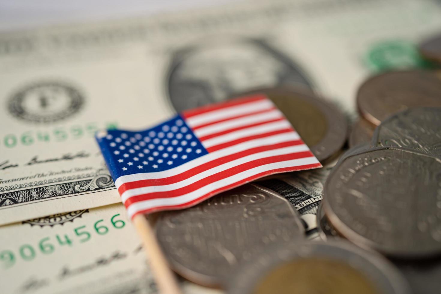 Stack of coins with USA America flag on USA America dollar banknotes. photo