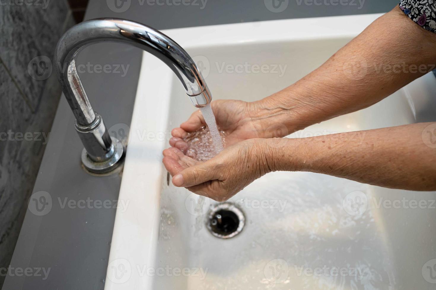 Asian washing hand by soap and clean water for protect safety infection and kill Covid-19 Coronavirus, bacteria and germs. photo