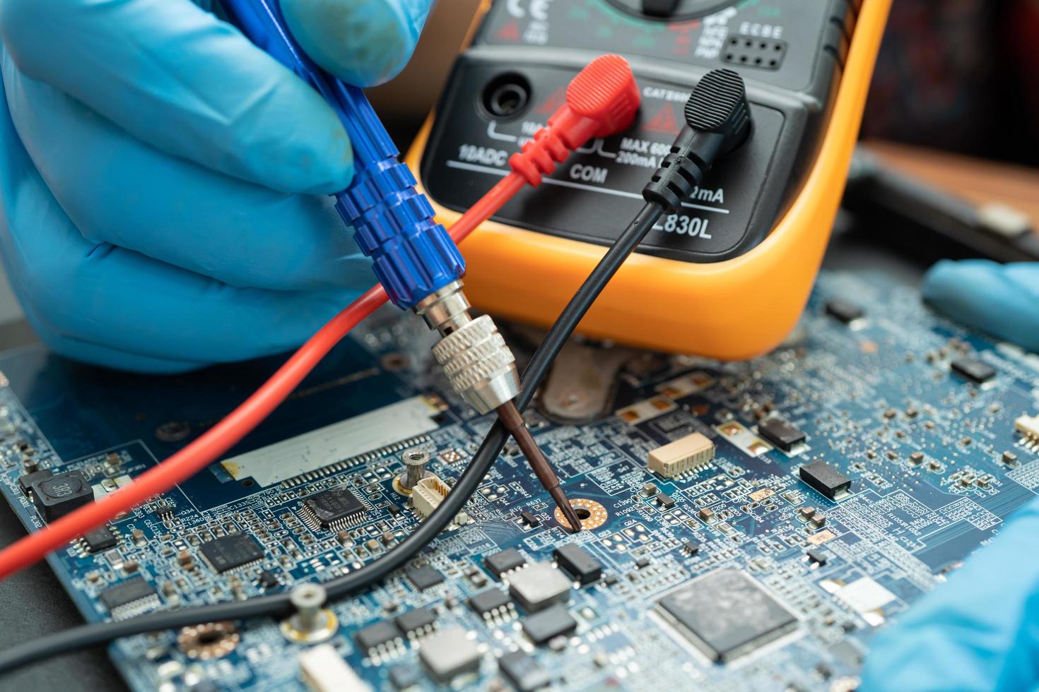 Technician repairing inside of hard disk by soldering iron. Integrated Circuit. The concept of data, hardware, technician and technology. photo