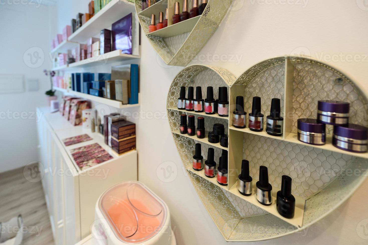 Cosmetic section with nail polish, facial cream, conditioners, shampoo and hair treatment photo