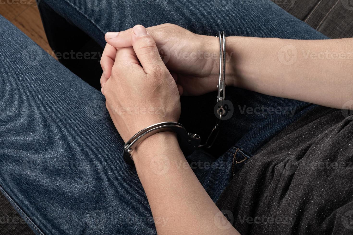 woman hands in  handcuffs , detention in a crime photo