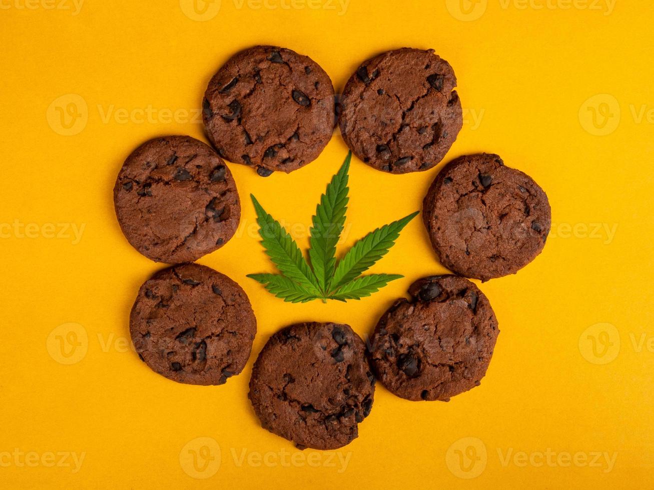 a circle of cannabis cookies with a green leaf in the middle, sweet marijuana food photo