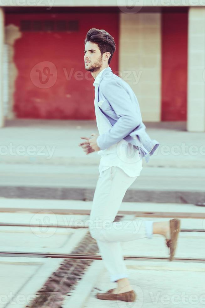 Attractive young handsome man, model of fashion in urban background photo