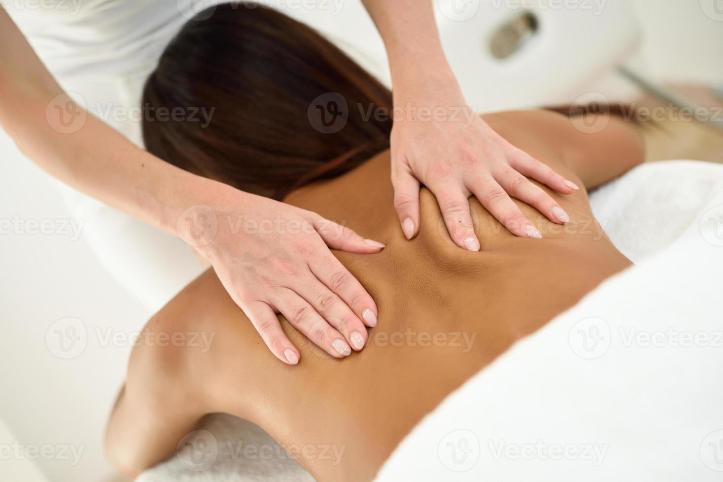 Arab woman receiving back massage in spa wellness center. photo