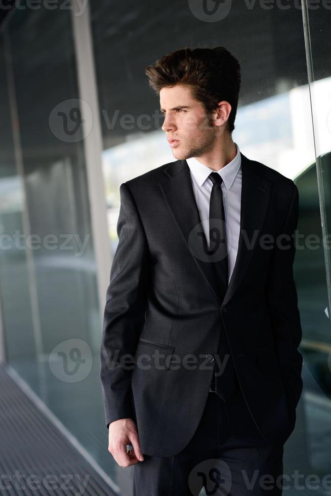 Attractive young businessman in urban background photo