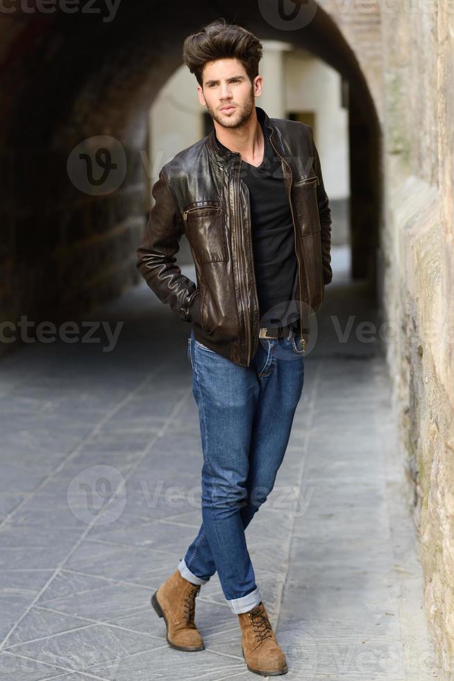 Attractive young handsome man, model of fashion in urban background photo