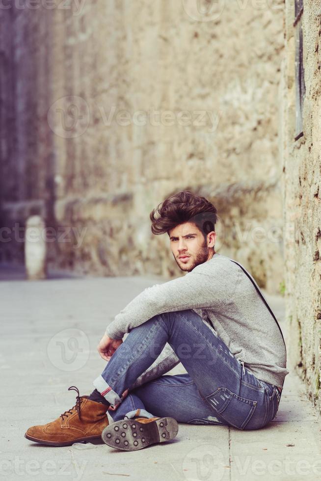 Hombre vestido con tirantes en el fondo urbano foto