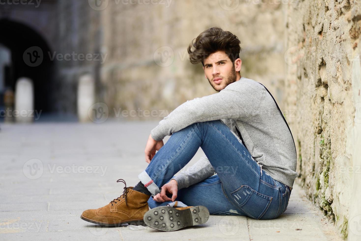 Man wearing suspenders in urban background photo