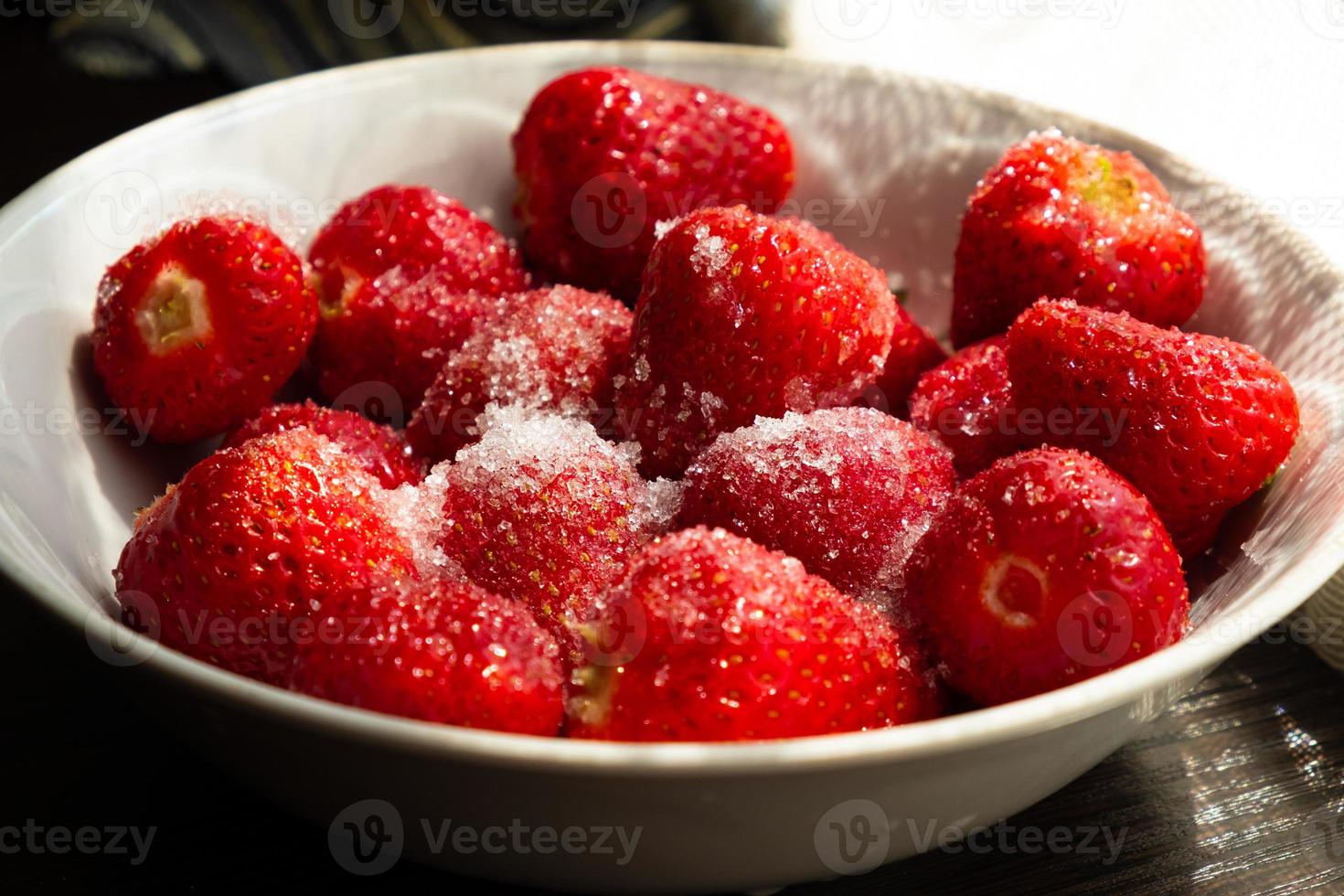 a plate of strawberries with sugar close up photo