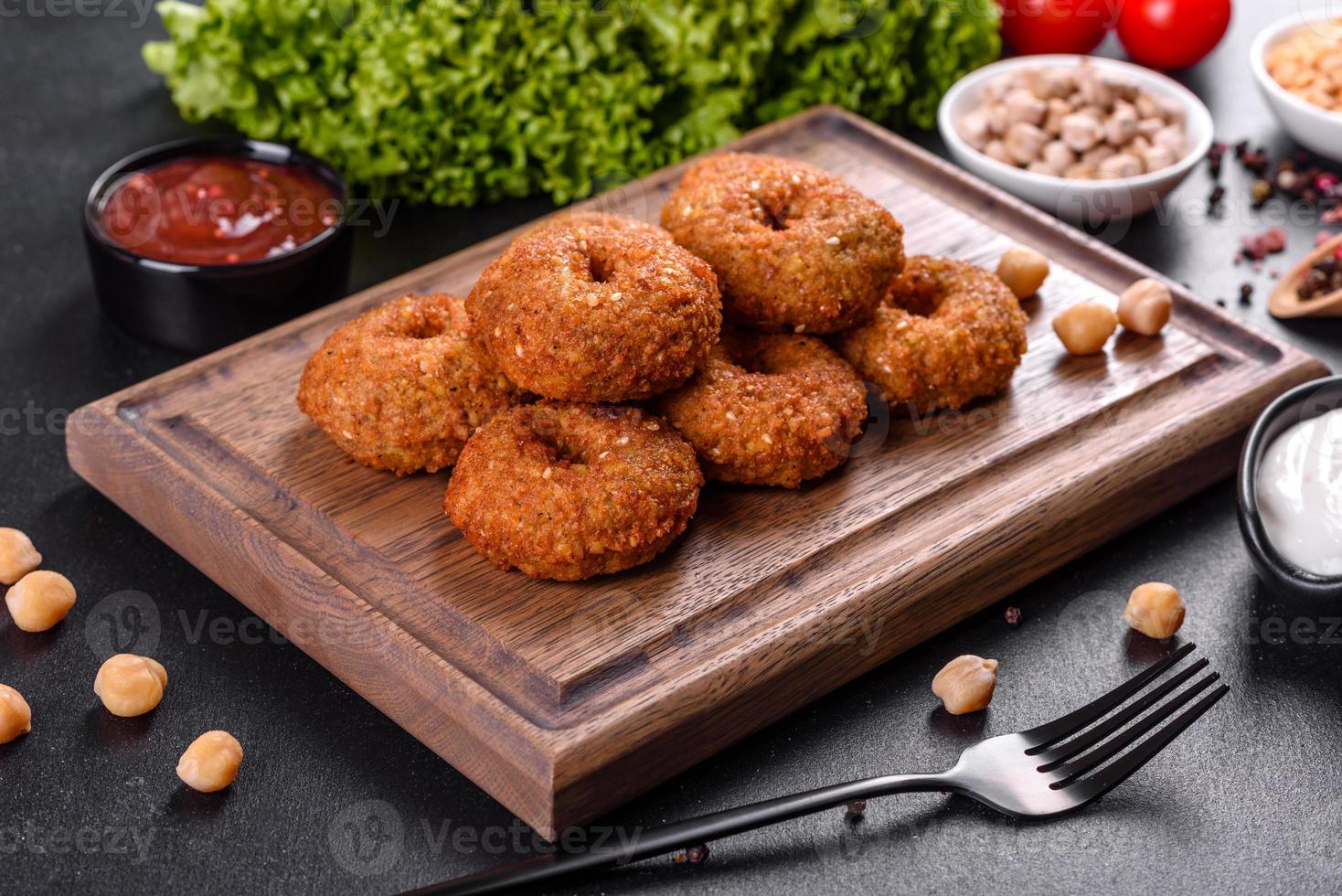 Beautiful delicious fresh chickpea falafel with sauces on a concrete background photo