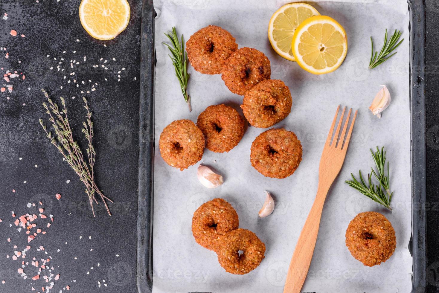 Beautiful delicious fresh chickpea falafel with sauces on a concrete background photo