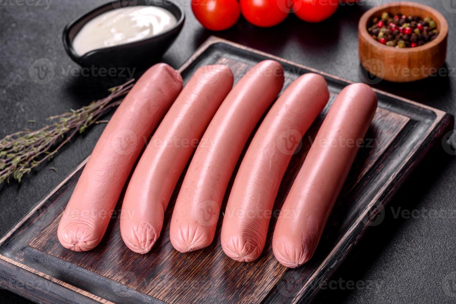 Delicious fresh boiled sausages with vegetables and spices photo