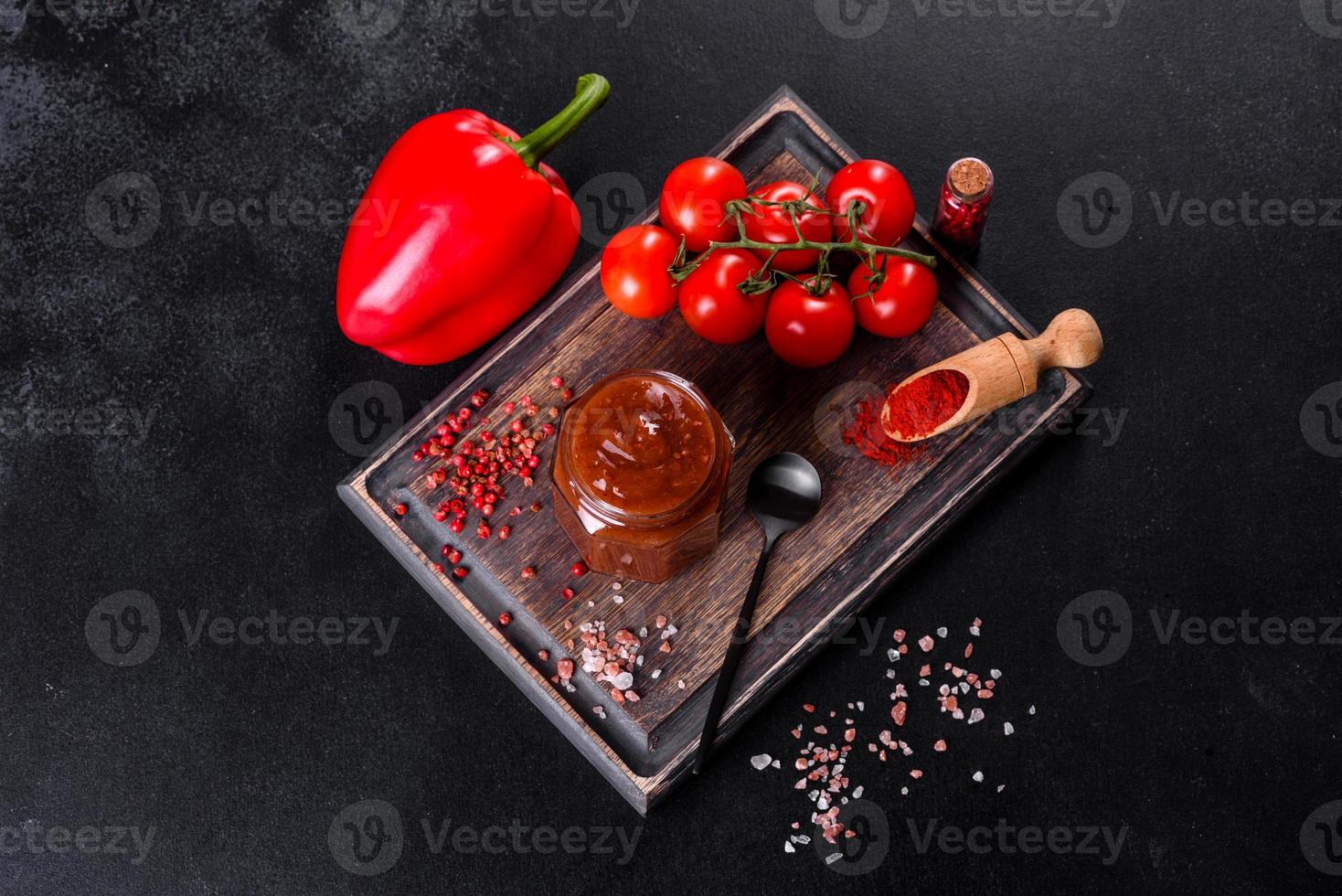 Spicy seasoning of Georgian cuisine adjika in a bowl with red pepper and garlic photo