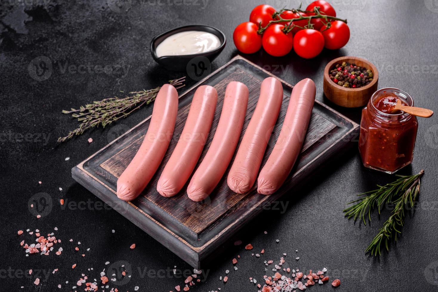 Delicious fresh boiled sausages with vegetables and spices photo