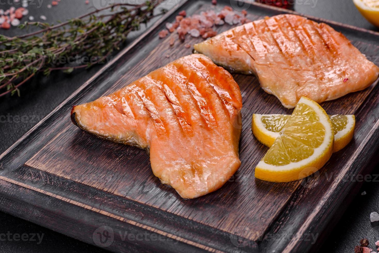 Tasty fresh red fish arctic char baked on a grill photo