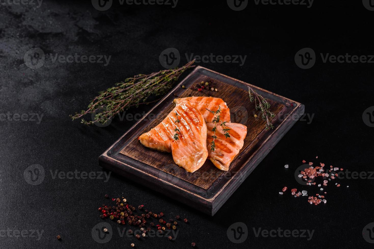 Tasty fresh red fish arctic char baked on a grill photo