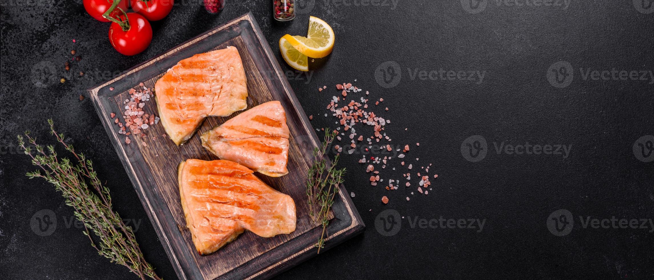 Tasty fresh red fish arctic char baked on a grill photo