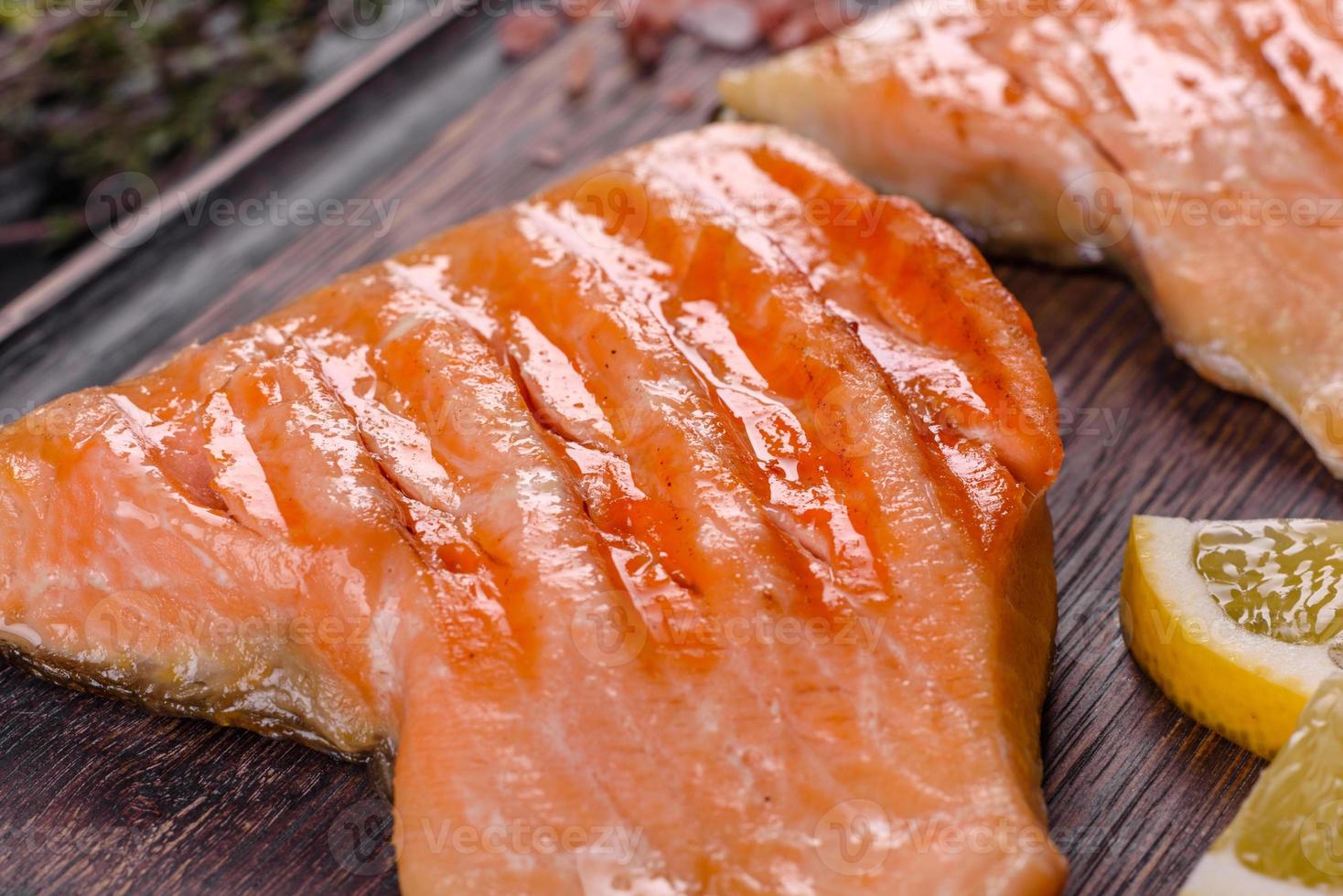 Tasty fresh red fish arctic char baked on a grill photo