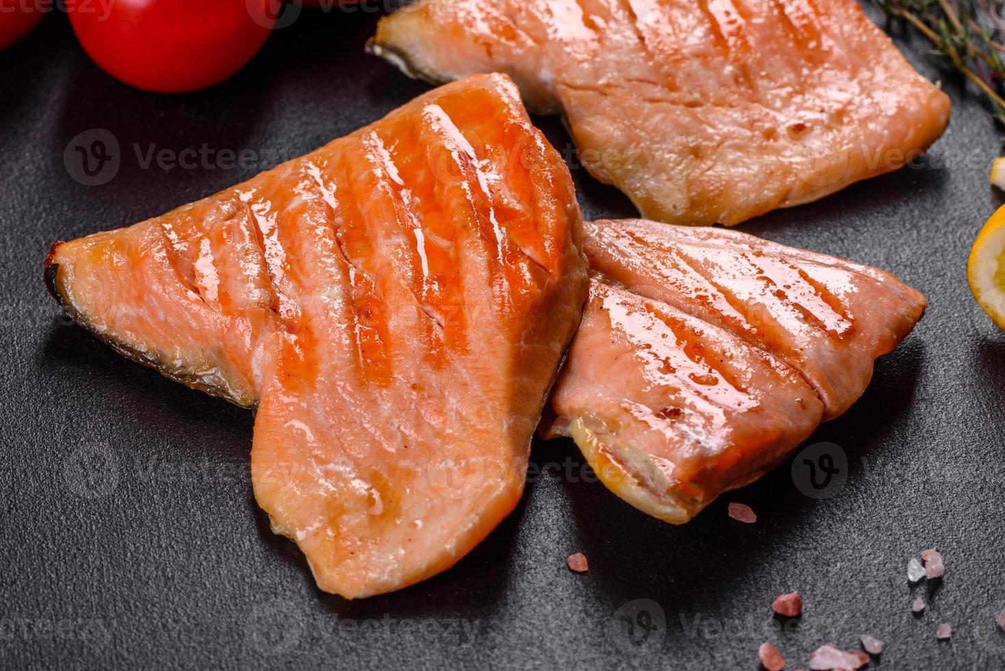 Tasty fresh red fish arctic char baked on a grill photo