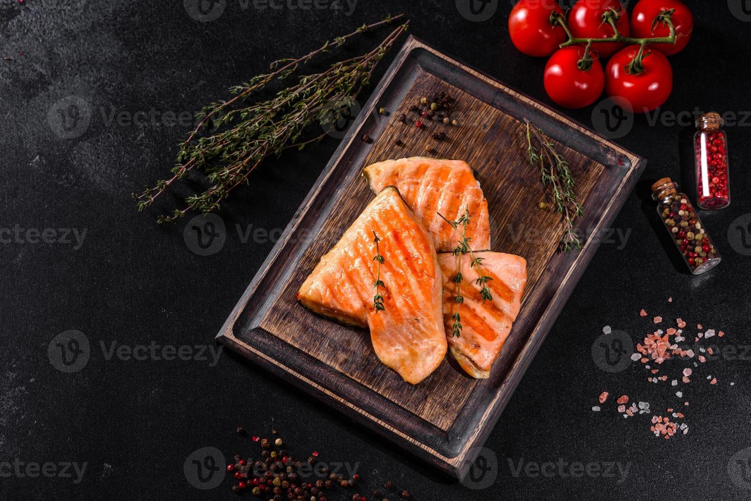 Tasty fresh red fish arctic char baked on a grill photo