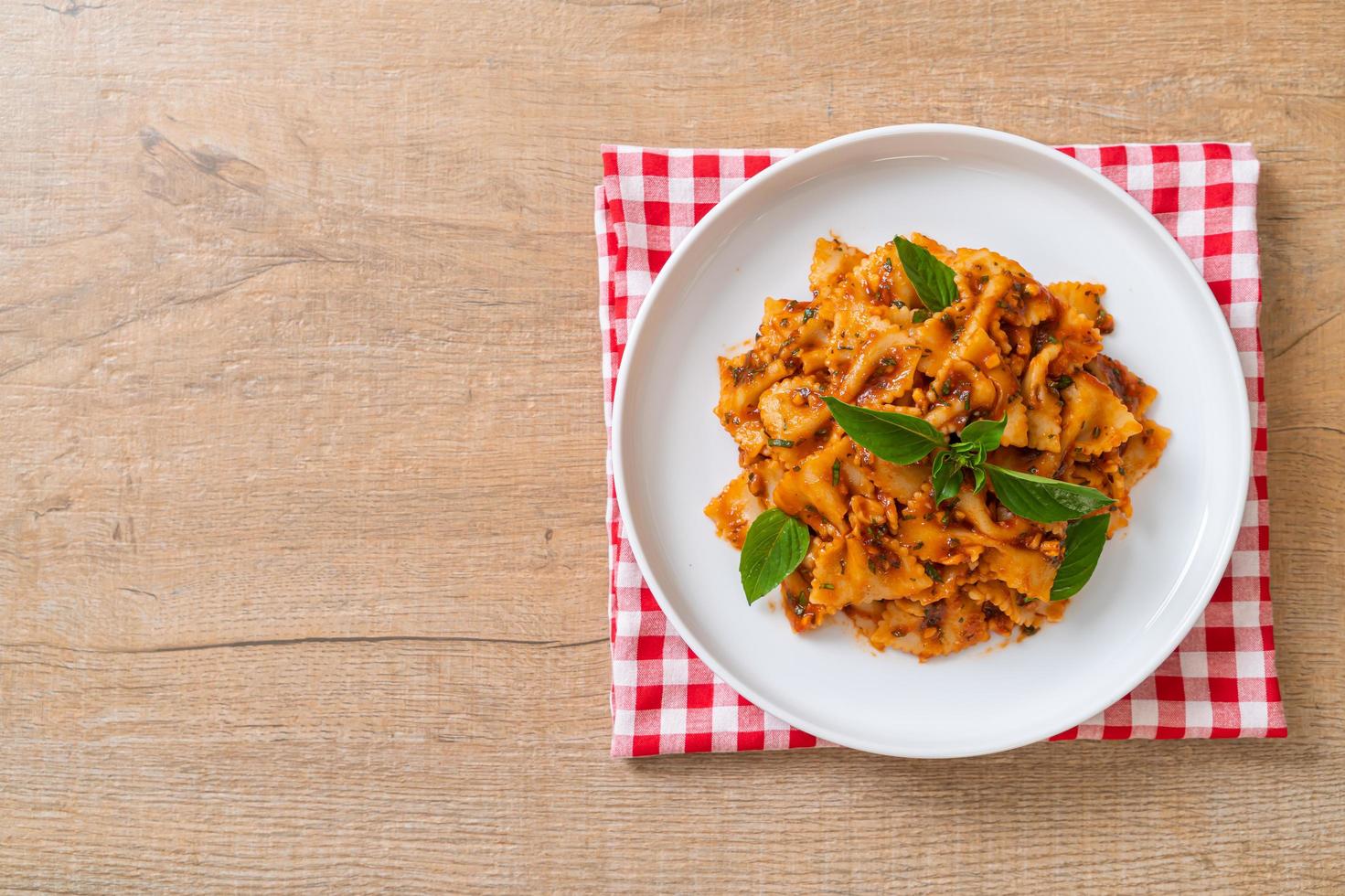 Farfalle pasta with basil and garlic in tomato sauce - Italian sauce photo