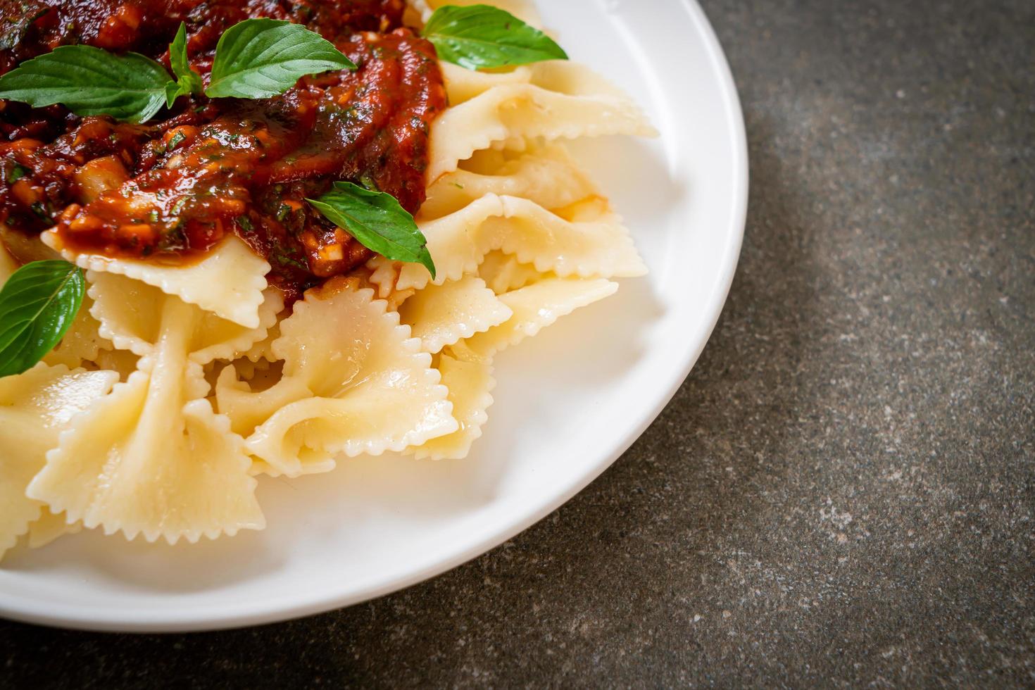 Farfalle pasta with basil and garlic in tomato sauce - Italian sauce photo