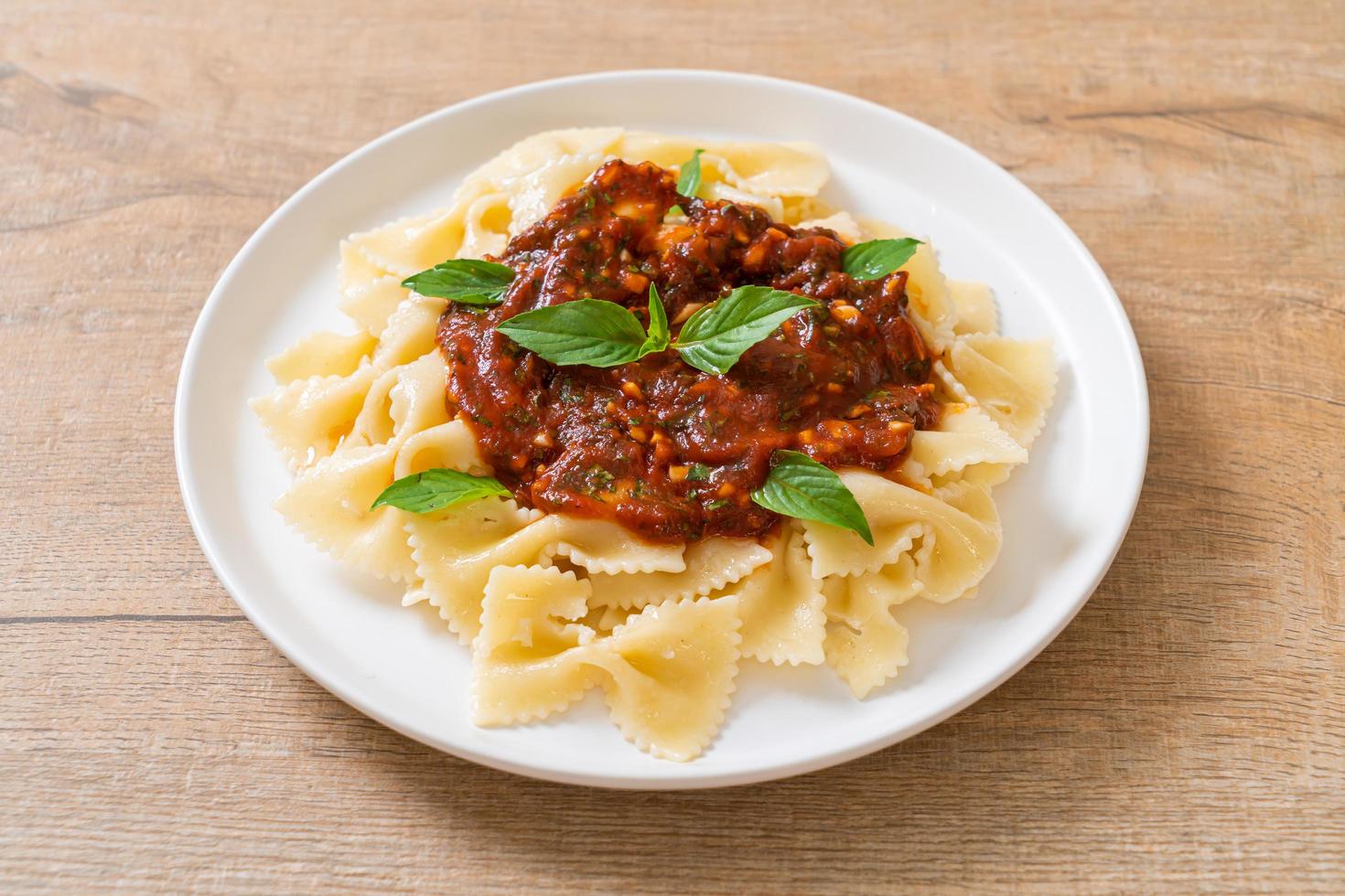 Farfalle pasta with basil and garlic in tomato sauce - Italian sauce photo