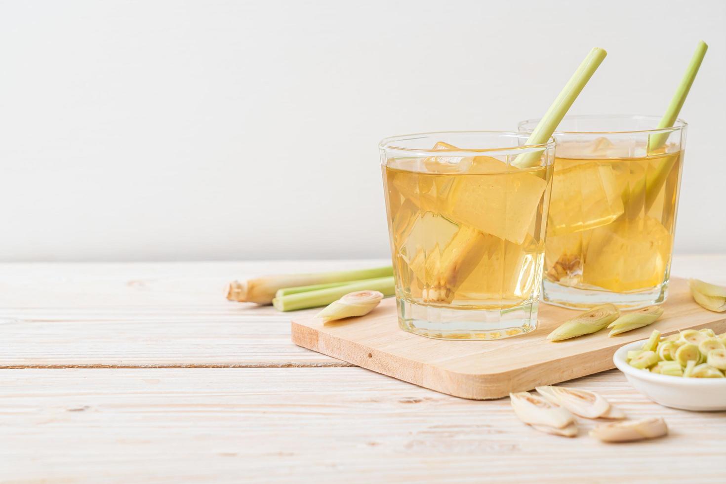 Iced lemon grass juice on wood background photo