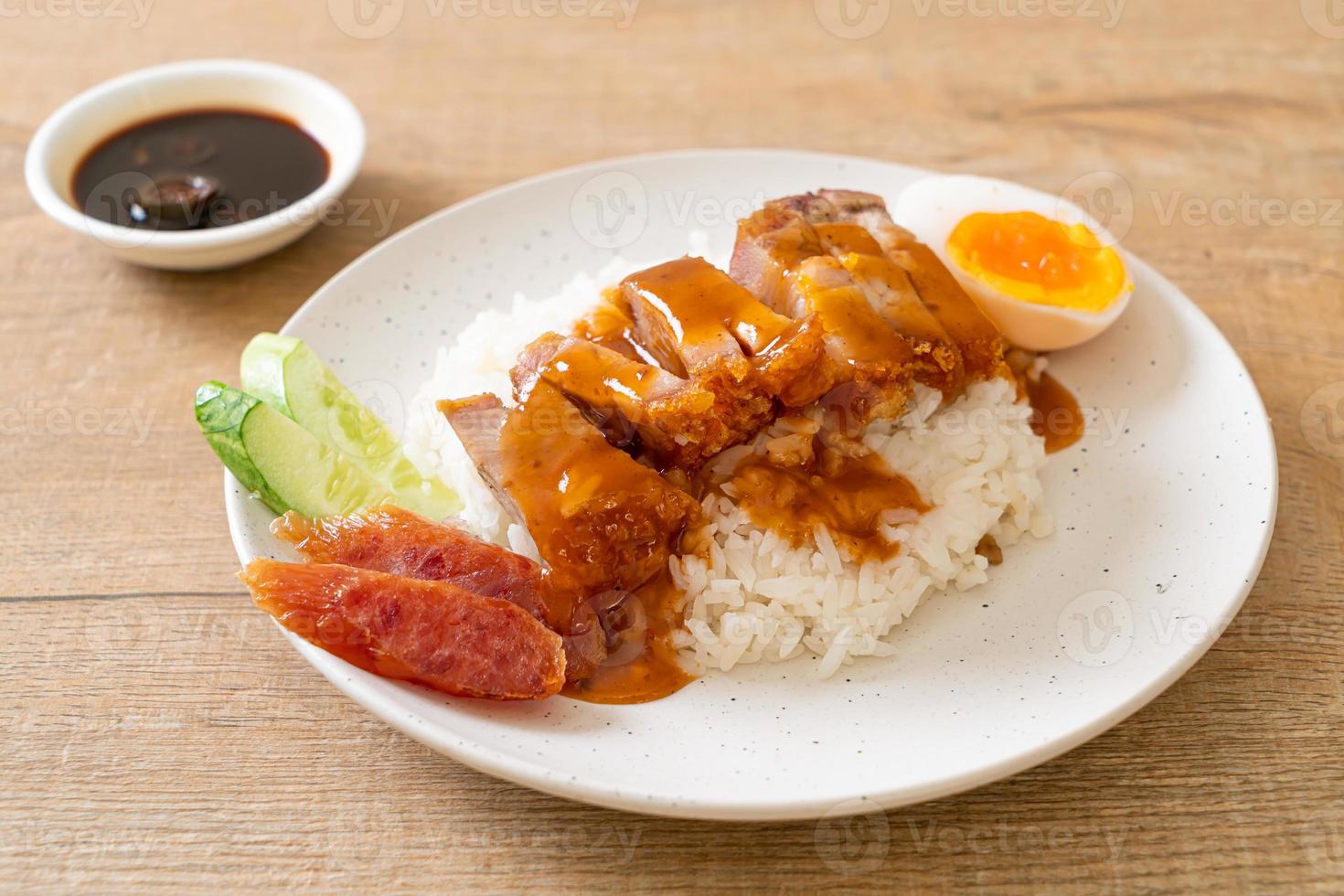 Crispy belly pork on rice with barbecue red sauce photo