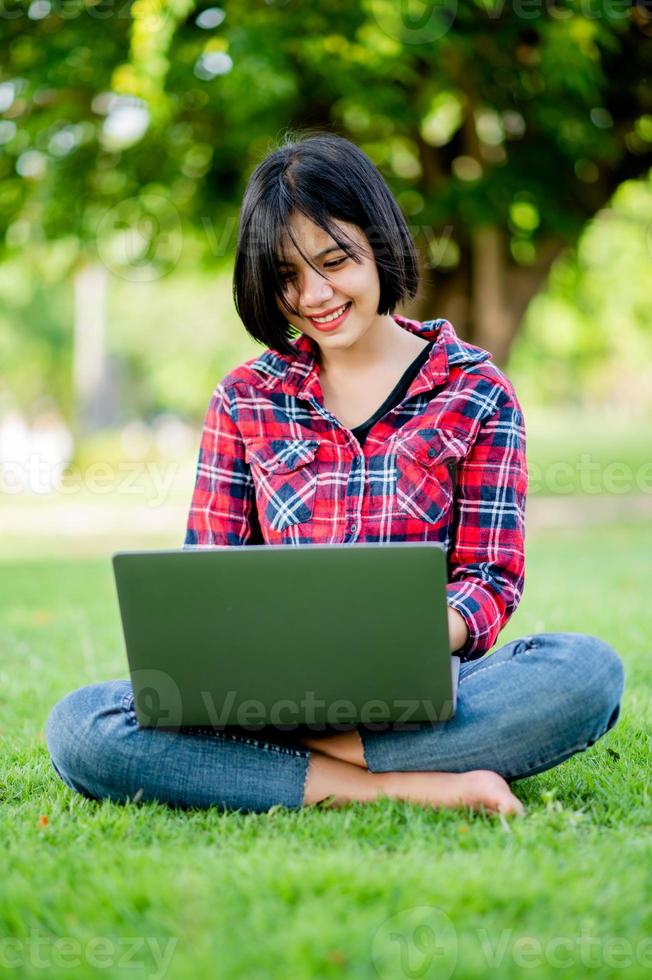 Asian women smile happily and laptop. Work online online communication Messaging Online learning Online communication concept photo