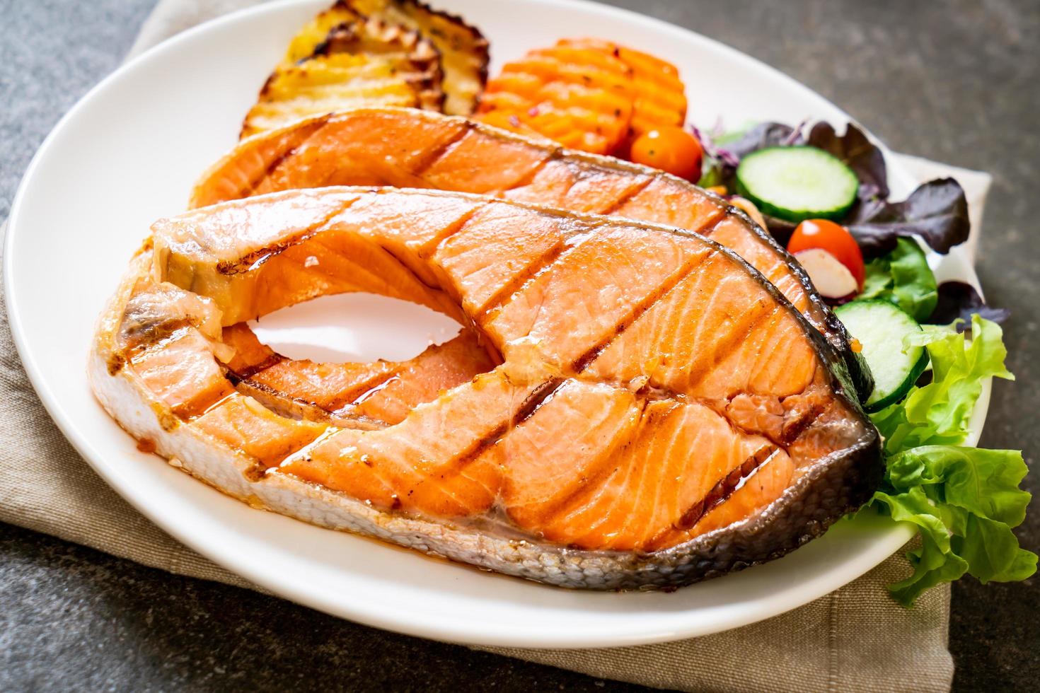 Double grilled salmon steak fillet with vegetables photo