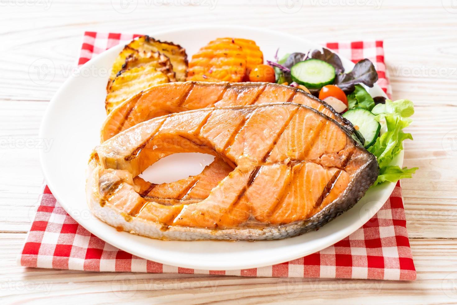 Double grilled salmon steak fillet with vegetables photo