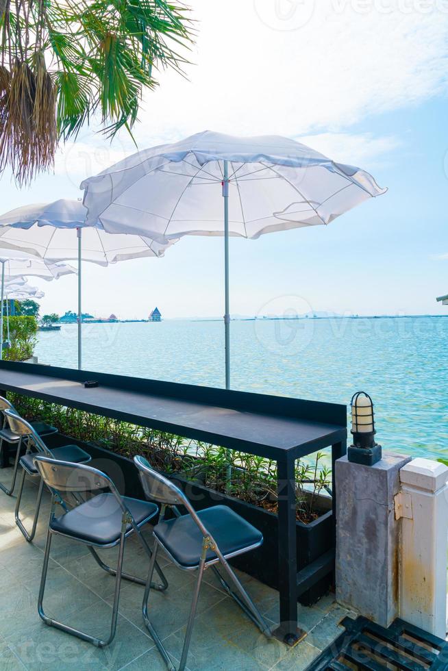 Empty outdoor bar and chairs with sea background photo