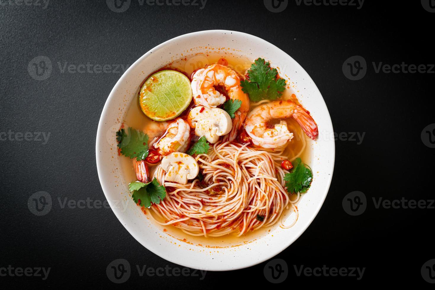 Noodles with spicy soup and shrimps or Tom Yum Kung - Asian food style photo