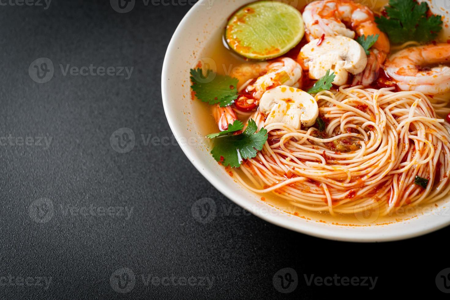 Noodles with spicy soup and shrimps or Tom Yum Kung - Asian food style photo