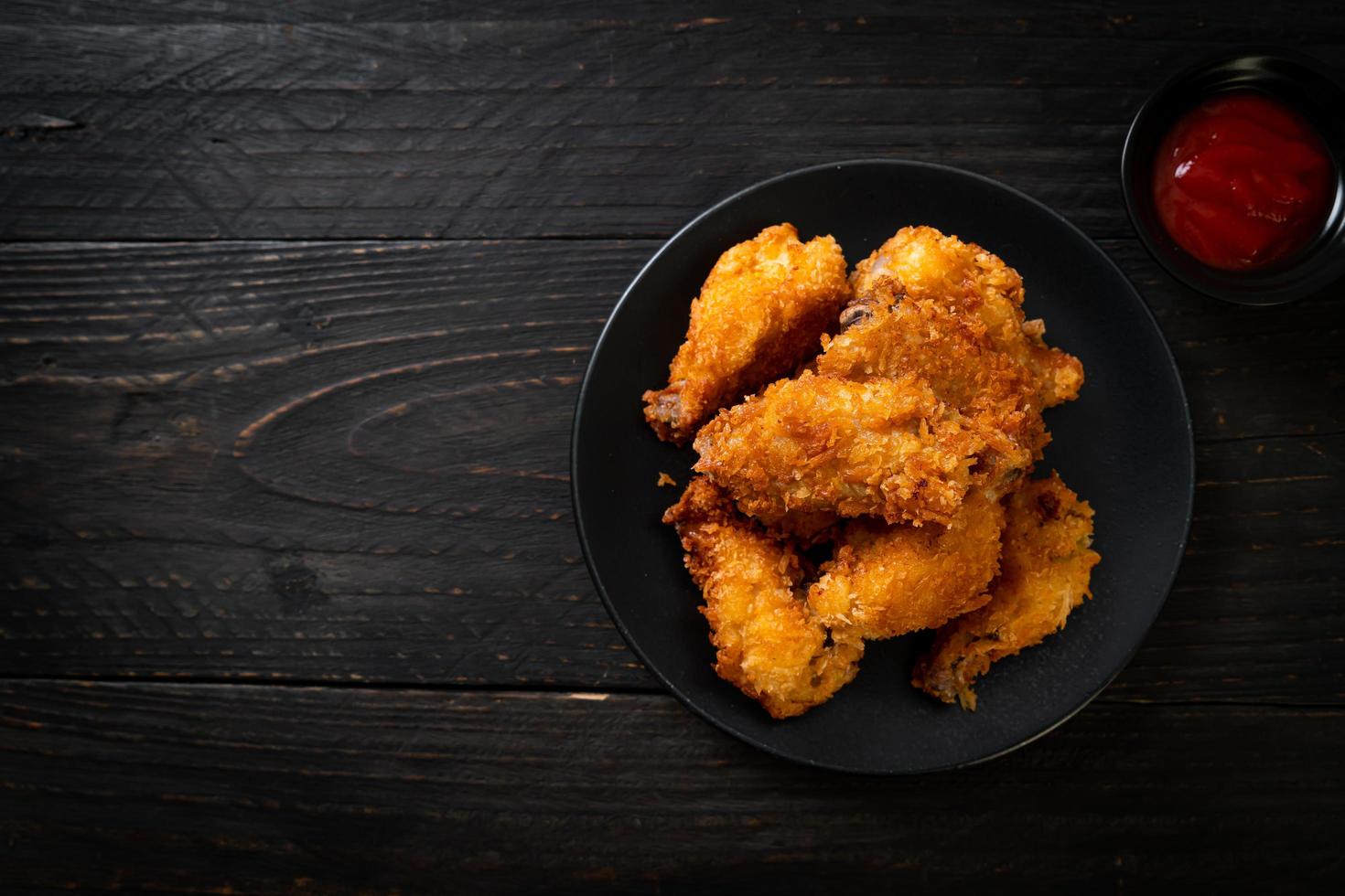 Fried chicken wings with ketchup - unhealthy food photo