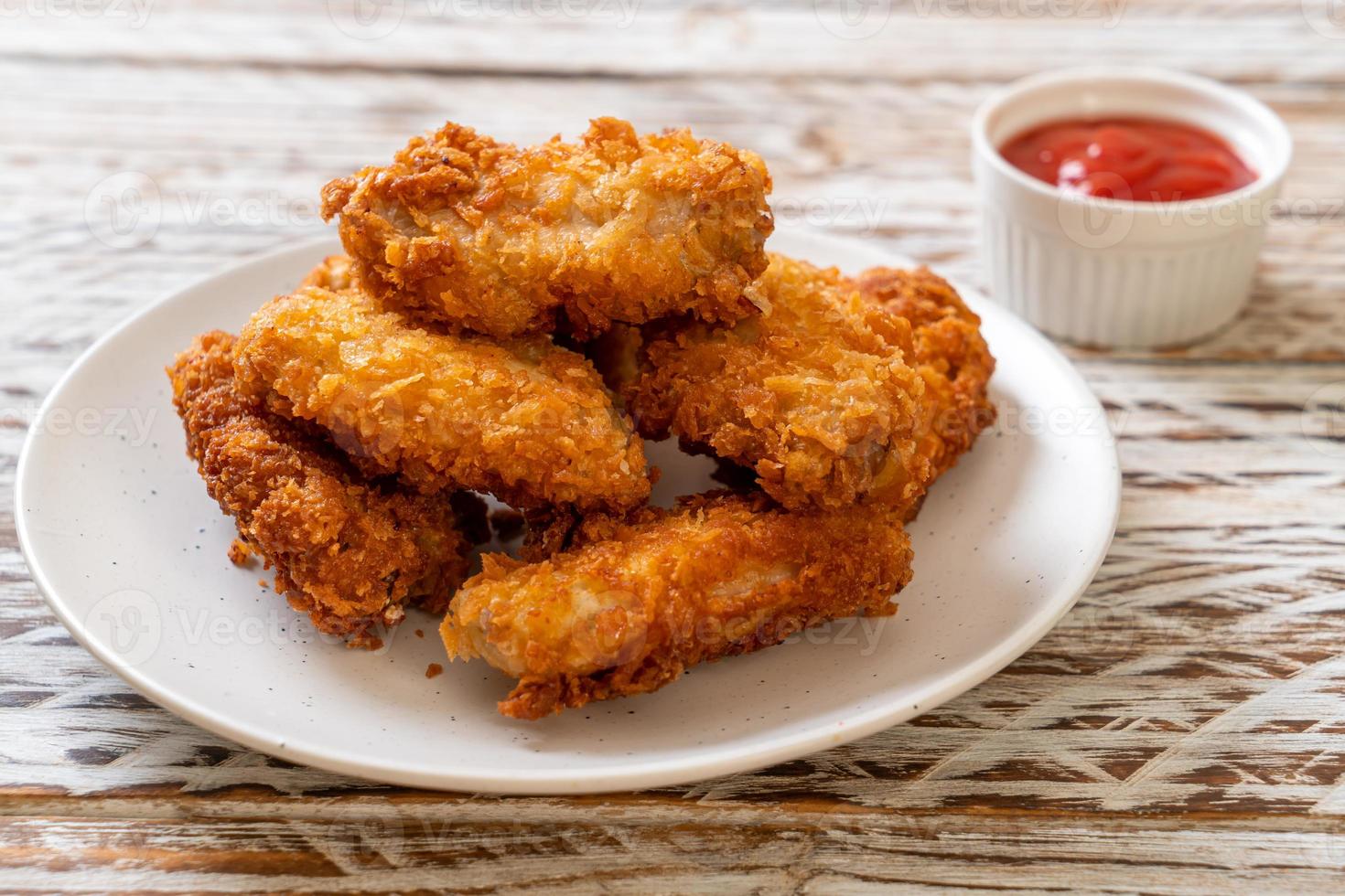 Fried chicken wings with ketchup - unhealthy food photo