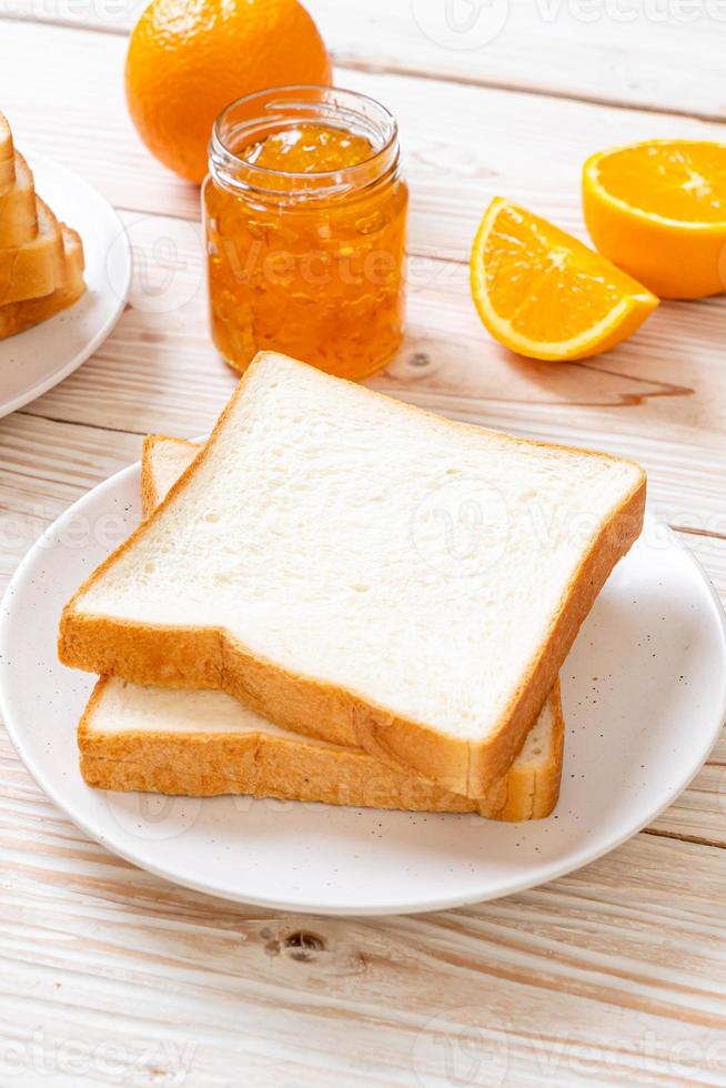 Slices of bread with orange jam photo